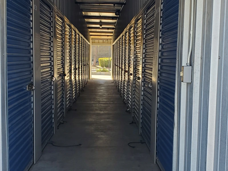inside row of storage units with blue doors and disc locks