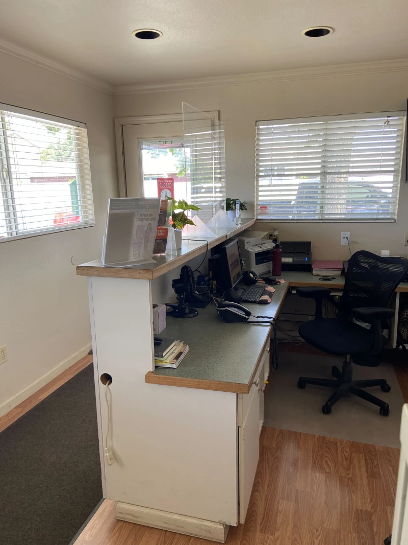 behind the reception desk with windows that look into the storage units