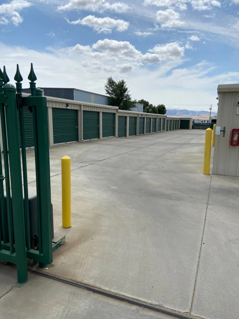 green metal gate open to the storage facility in avenal ca