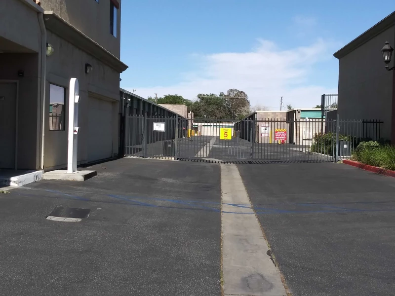 Storage facility front gate leading to multiple rows of storage buildings