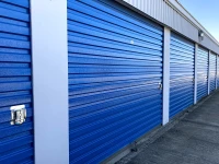 close up view of blue mini storage doors numbered 64