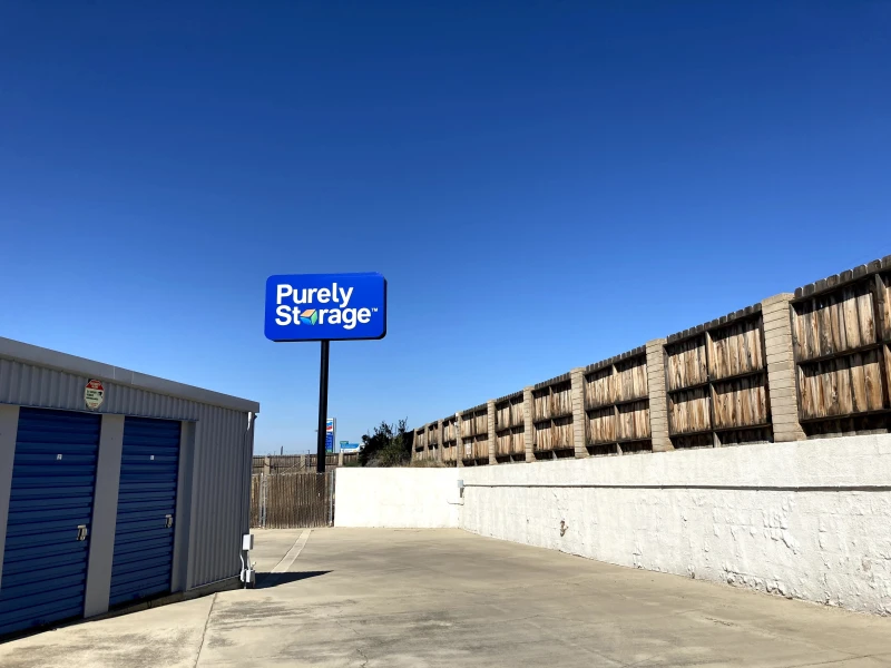 looking past blue and grey storage units up at a large purely storage logo sign